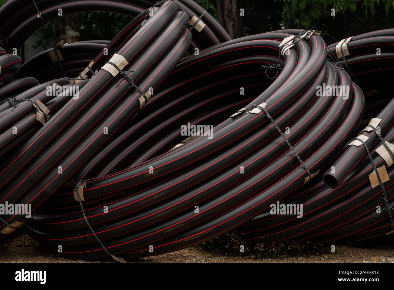 Pipe Red Line Black rubber or plastic pipes with a red lines as a construction ...