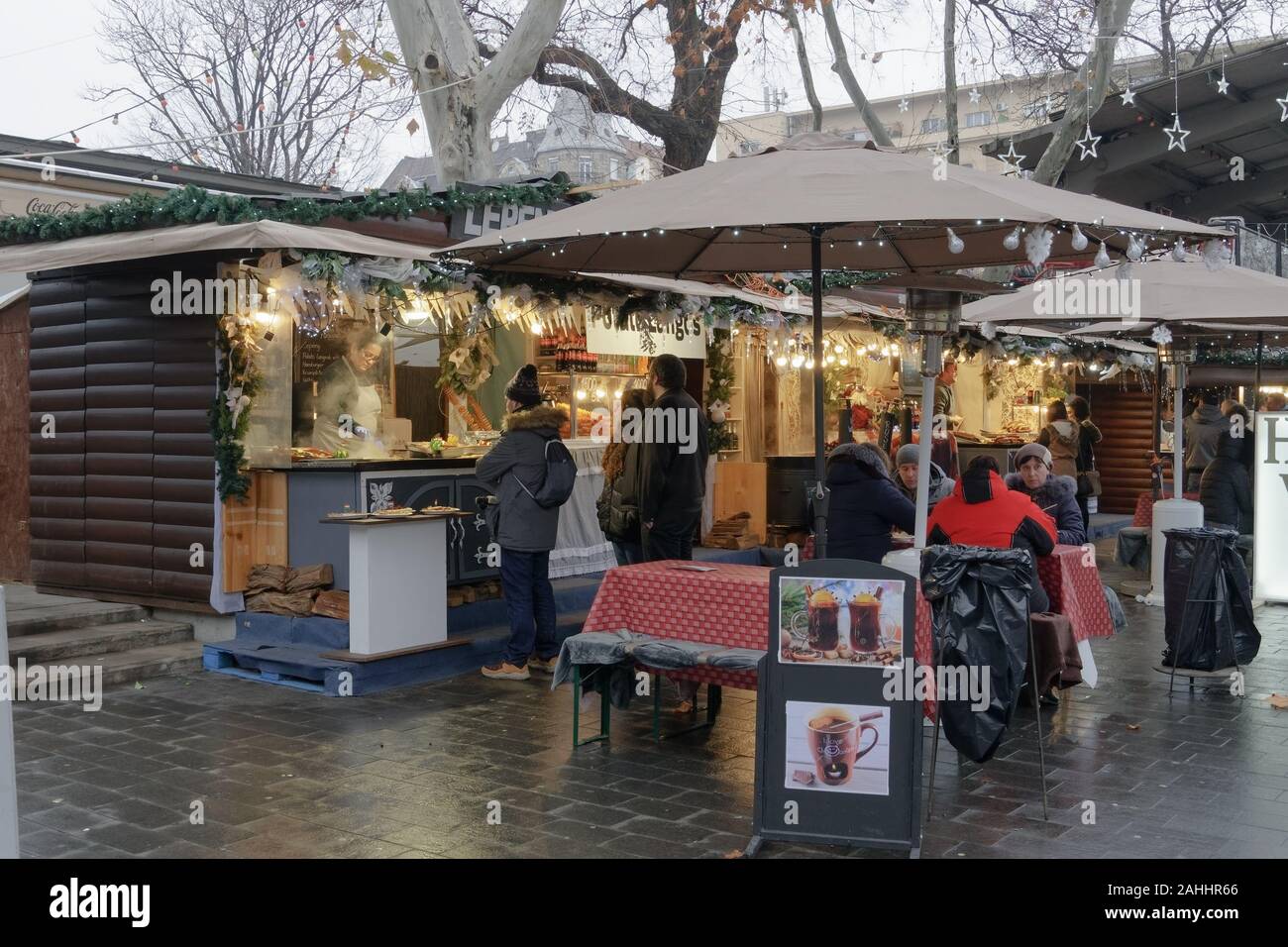 Budapest, Hungary Deak Ferenc square open air Christmas food market. Traditional seasonal food & mulled wine stalls on square with Hungarian vendors. Stock Photo