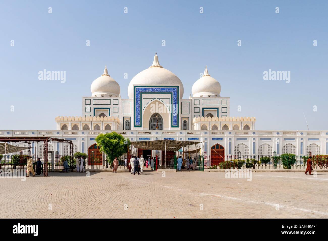 Larkana Bhutto Family Mausoleum Picturesque View with Visitors Entering and Exiting the Shrine on a Sunny Blue Sky Day Stock Photo