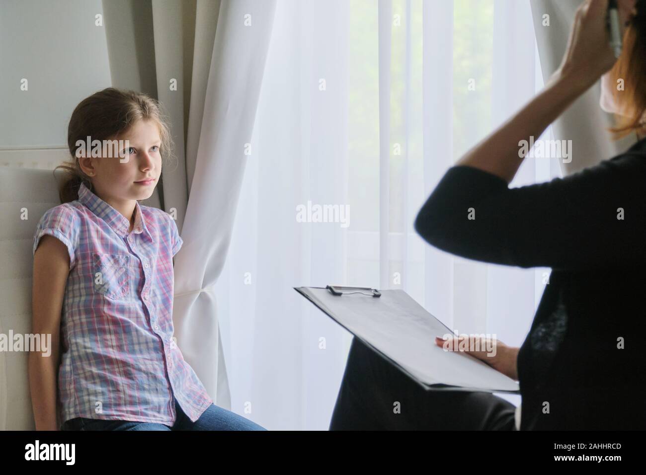 Meeting child girl with school counselor therapist. Children mental