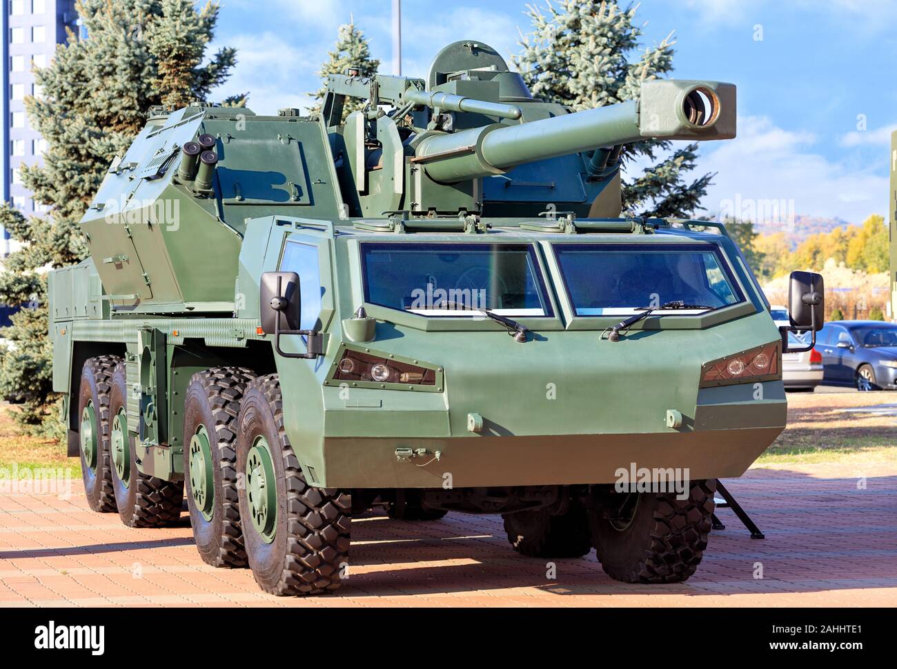 An army military vehicle with artillery anti-aircraft gun and guided missiles on board is parked in a car park on a bright summer day. Stock Photo