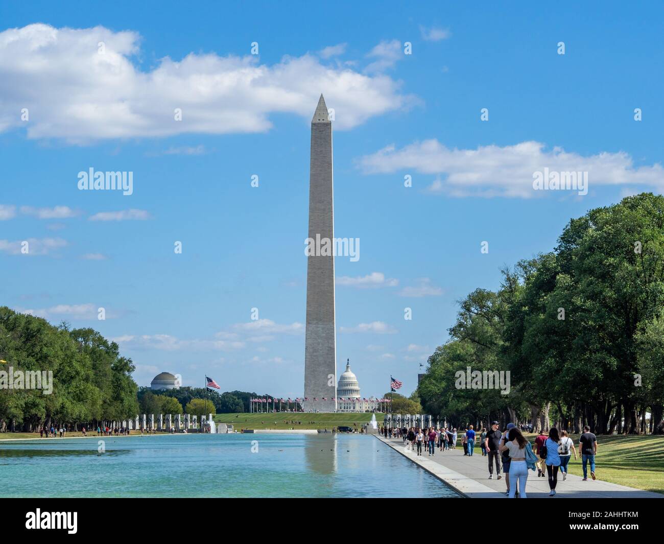 Washington, District of Columbia, United States of America - Washington monument park, obelisk on national mall, American flags and US capitol Stock Photo