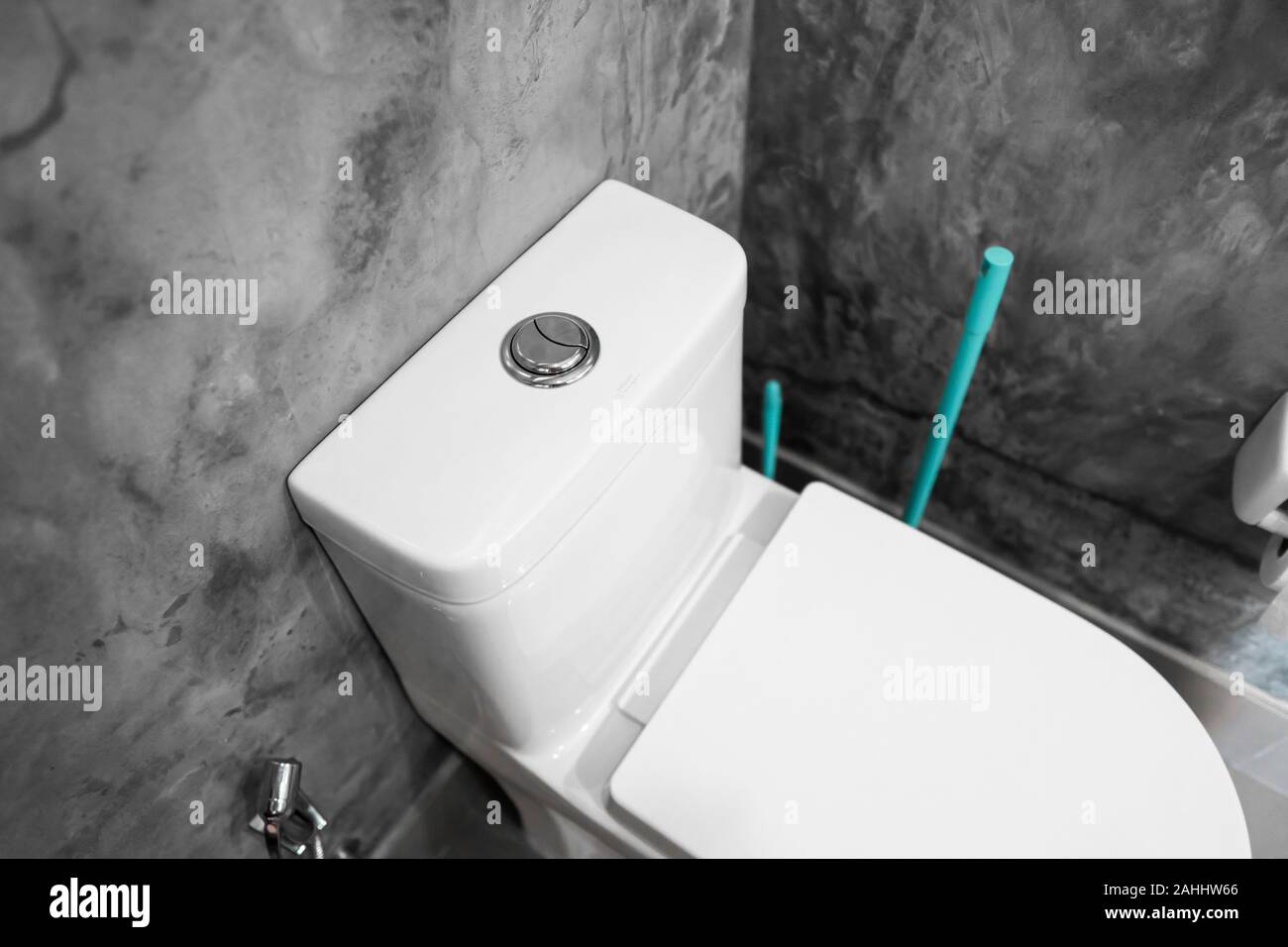 Close up on a flush toilet button for cleaning a toilet. Stock Photo