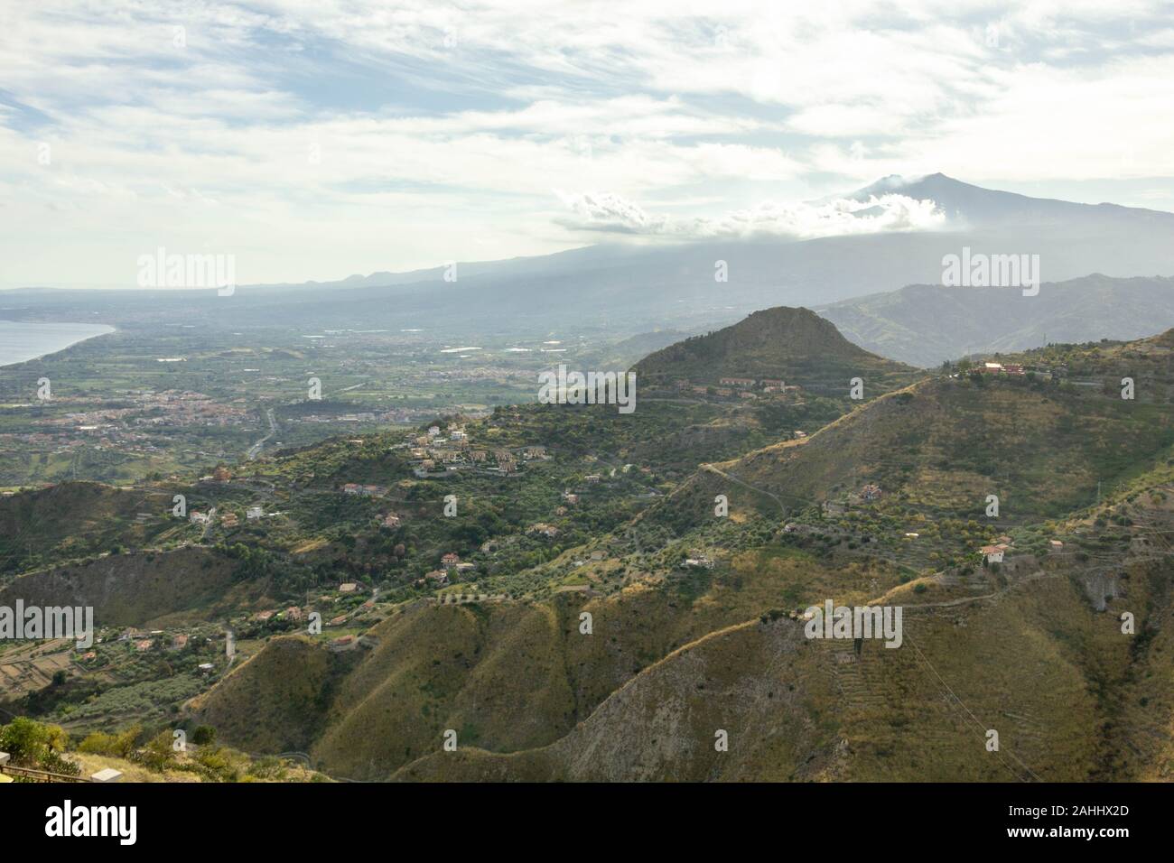 View of the Etna volcano in the clouds from Castelmola Sicily Stock Photo