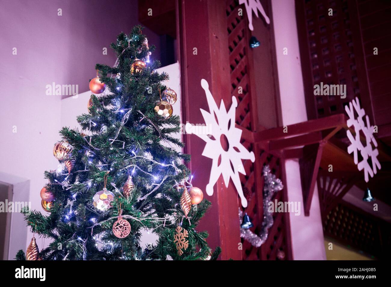 Christmas tree with LED light and many things decorate on it inside house Stock Photo
