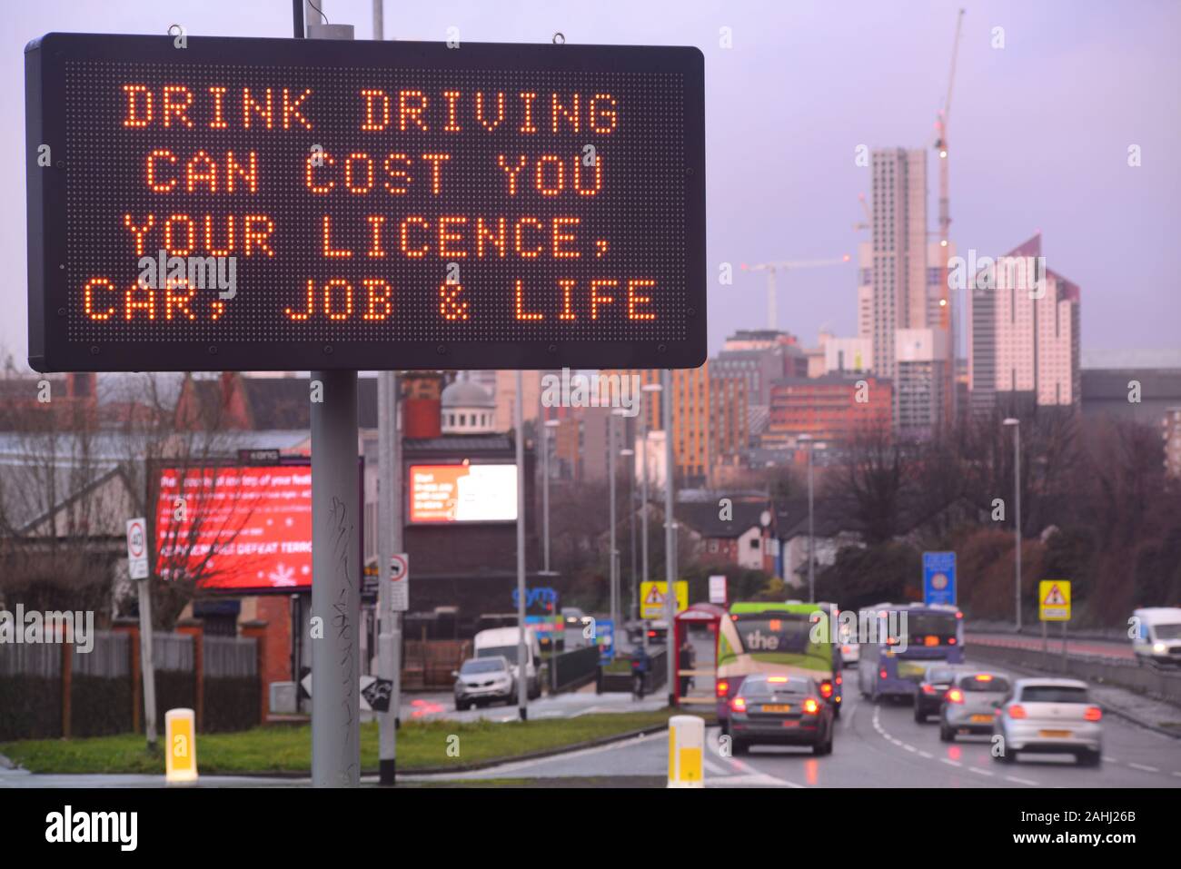 traffic passing digital roadside sign warning drivers against drink driving leeds, united kingdom Stock Photo