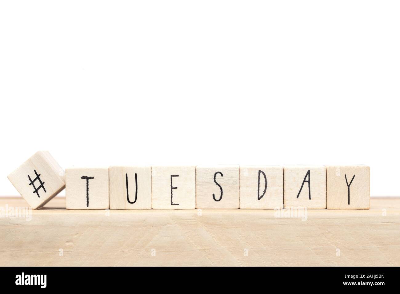 Wooden cubes with a hashtag and the word Tuesday, social media concept ...