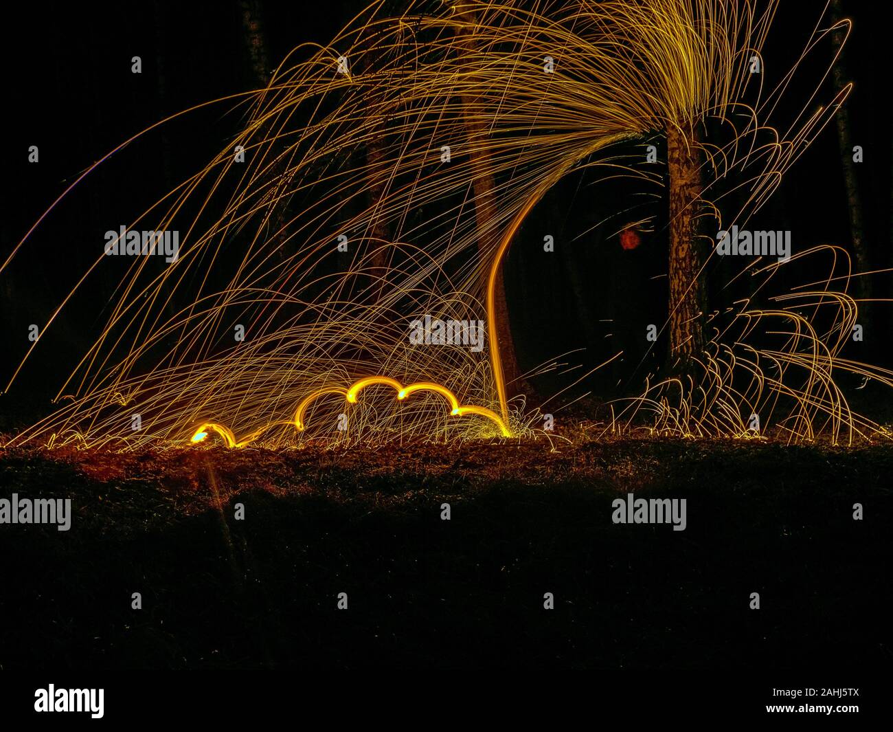Fire circle spinning from steel wool creating spiral spark, Steel wool