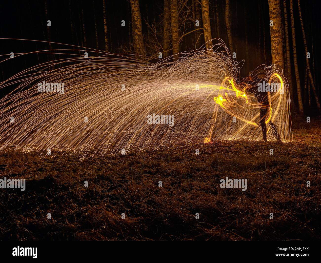Fire circle spinning from steel wool creating spiral spark, Steel wool