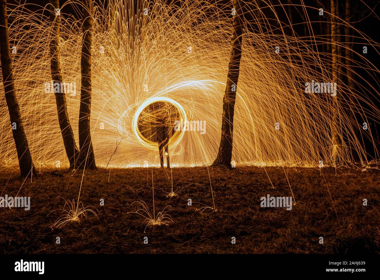 Fire circle spinning from steel wool creating spiral spark, Steel wool