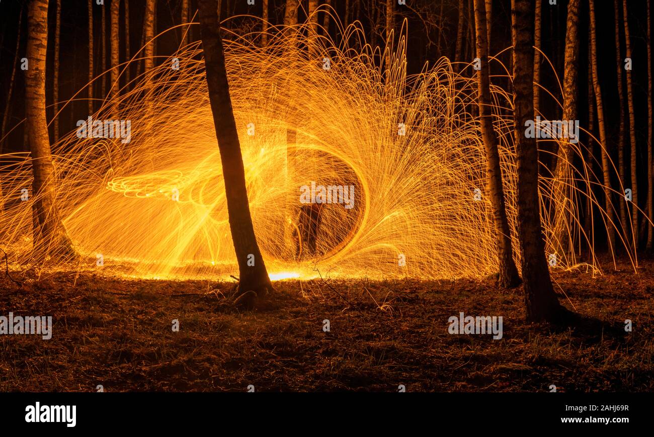 Fire circle spinning from steel wool creating spiral spark, Steel wool