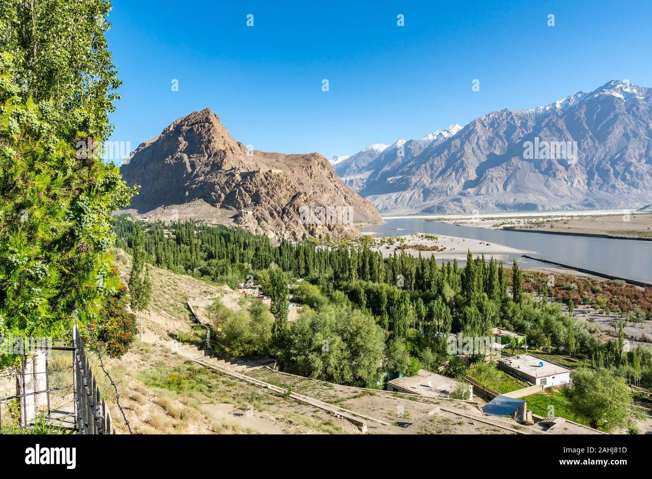 Skardu City Landscape Picturesque Panoramic View of Indus River and Snow Capped Mountains on a Sunny Blue Sky Day Stock Photo
