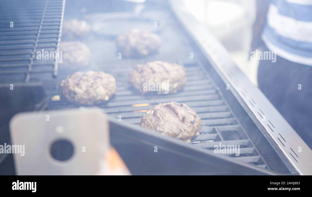 Cooking hamburger beef patties on a gas grill Stock Photo Alamy
