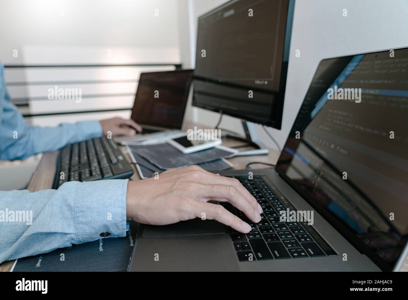 Programmer Typing Code on desktop computer, Developing programming and ...