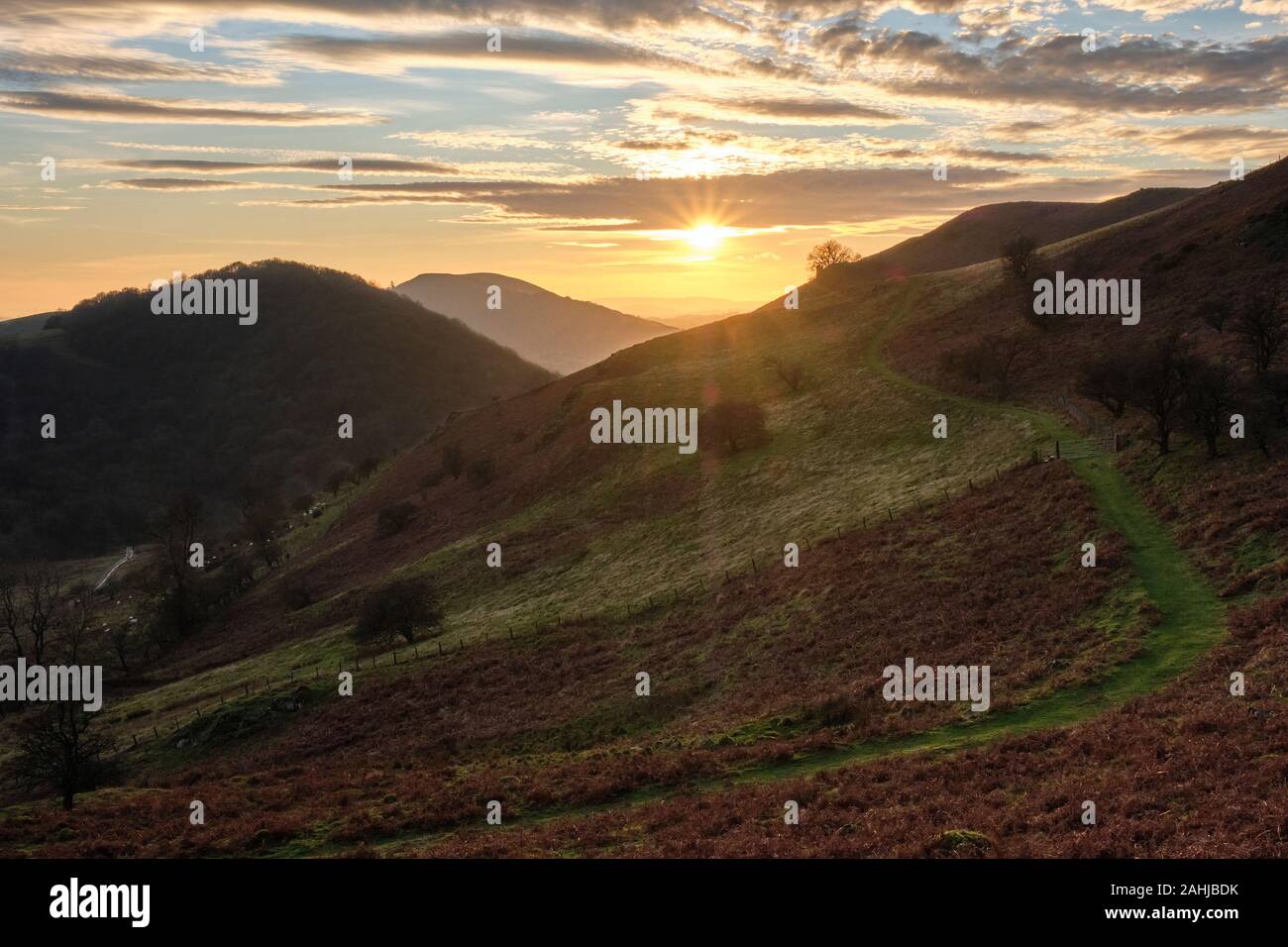 Sunset over Ragleth Hill, Helmeth Hill and the lower slopes of Caer Caradoc, near Church Stretton, Shropshire Stock Photo