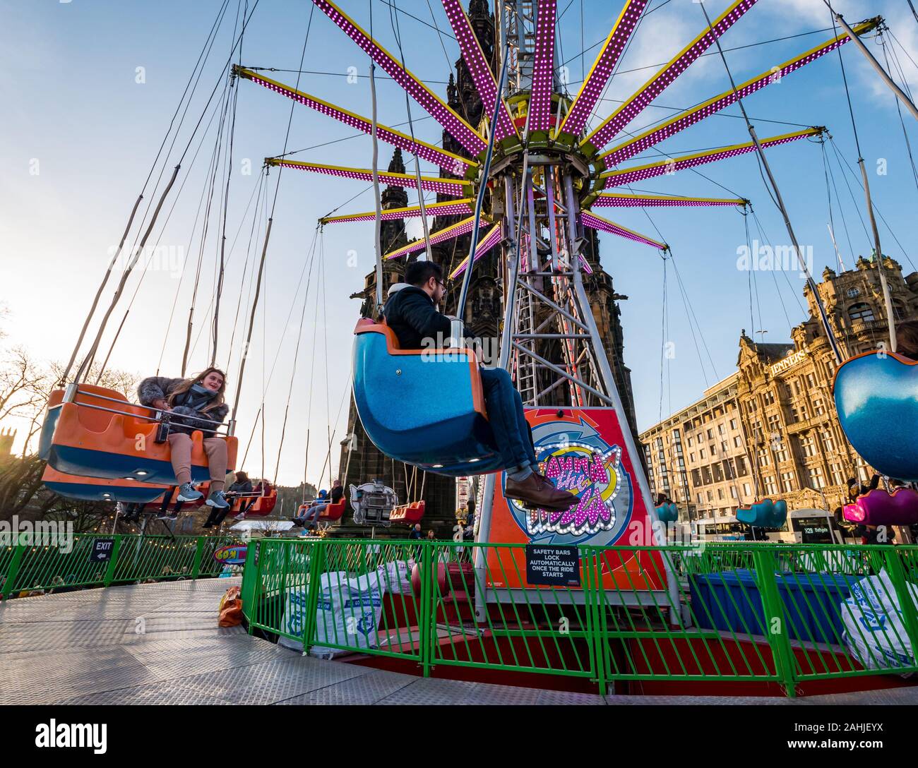 People lifting off in star flyer fairground ride, Princes Street Gardens at Christmas, Edinburgh, Scotland, UK Stock Photo