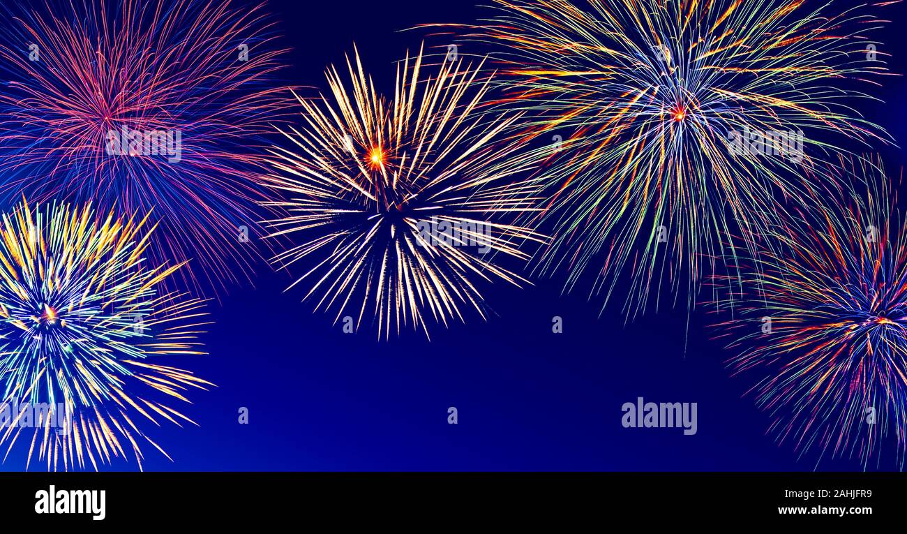 Banner with colorful fireworks over night sky with copy space. Stock Photo