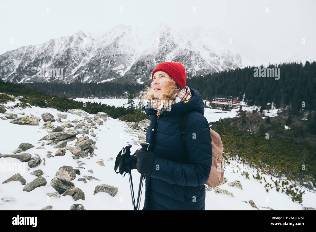 Woman trekking in snowy High Tatra mountains in winter close to Popradske Pleso, Slovakia Stock Photo