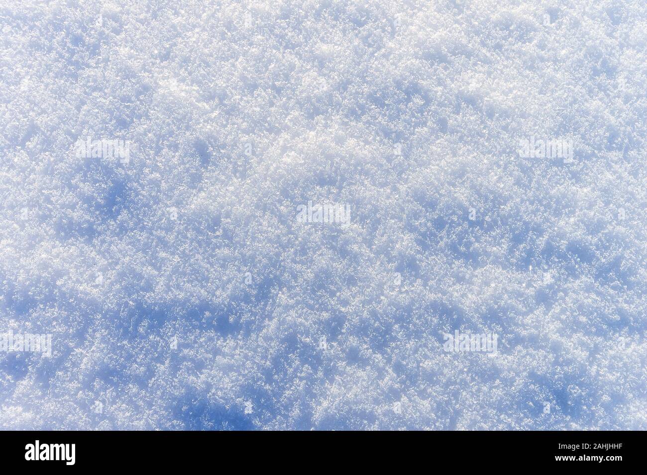 Snow texture at sunny winter day. Abstract background with shadows and ...