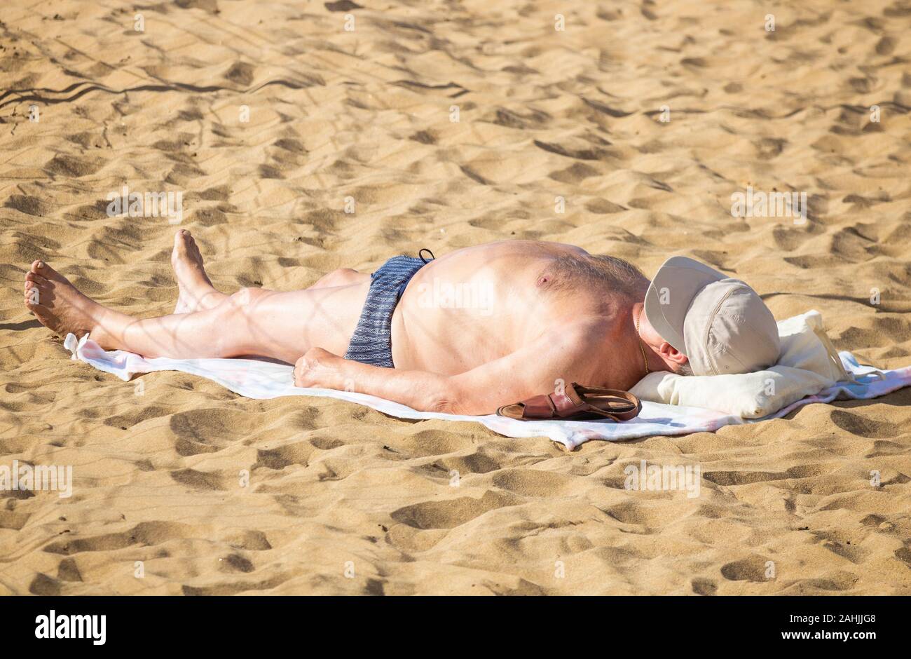 Tourists sunbathing on beach in Spain Stock Photo