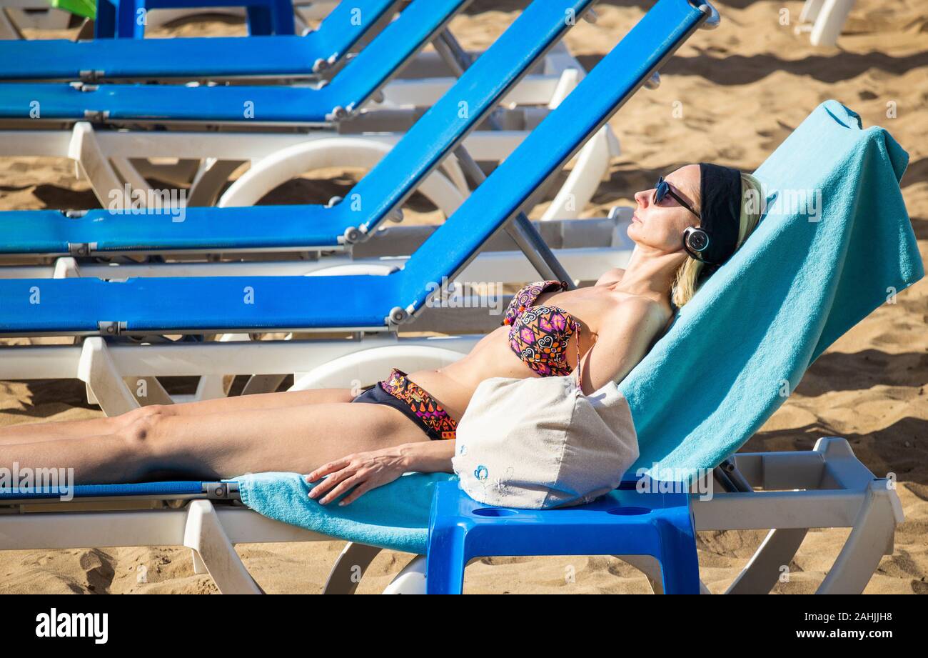 Tourists sunbathing on beach in Spain Stock Photo