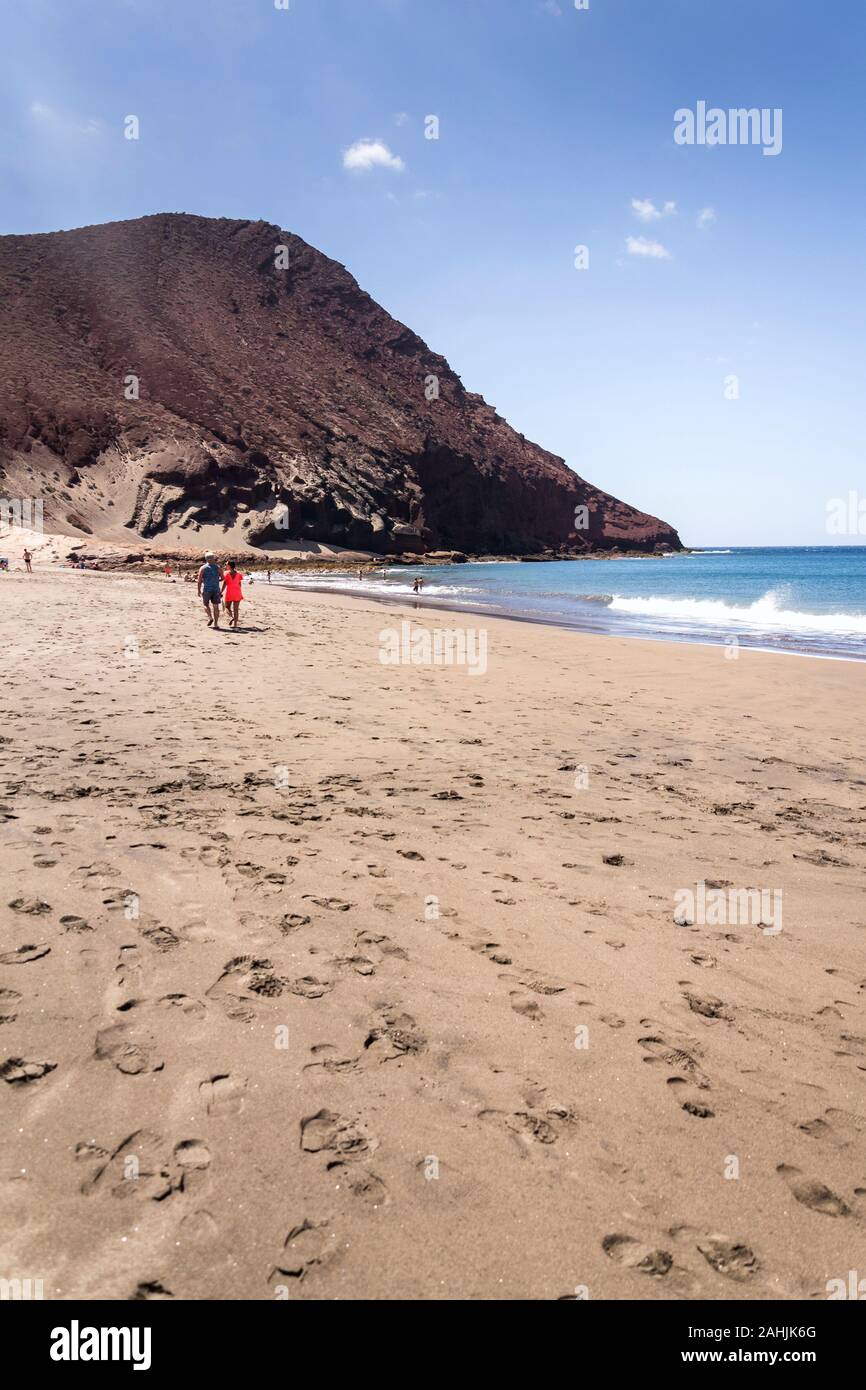 Unrecognizable people swimming, sunbathing and walking on La Tejita beach in Granadilla de Abona municipality, El Medano, Tenerife, Canary Islands Stock Photo