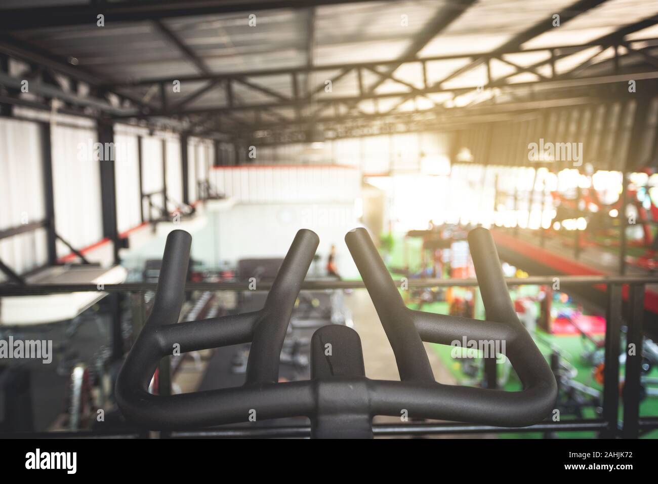 hand holding of bicycle training with fitness center on background Stock Photo