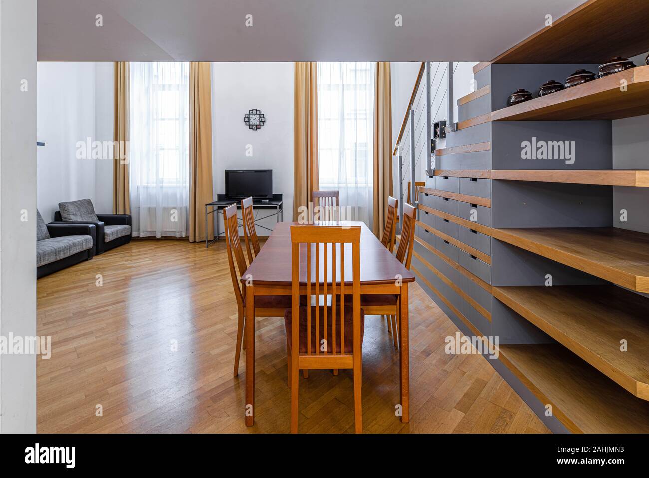 Wooden Table And Chairs Modern Light Interior Of Studio Apartment Staircase Private House Stock Photo Alamy