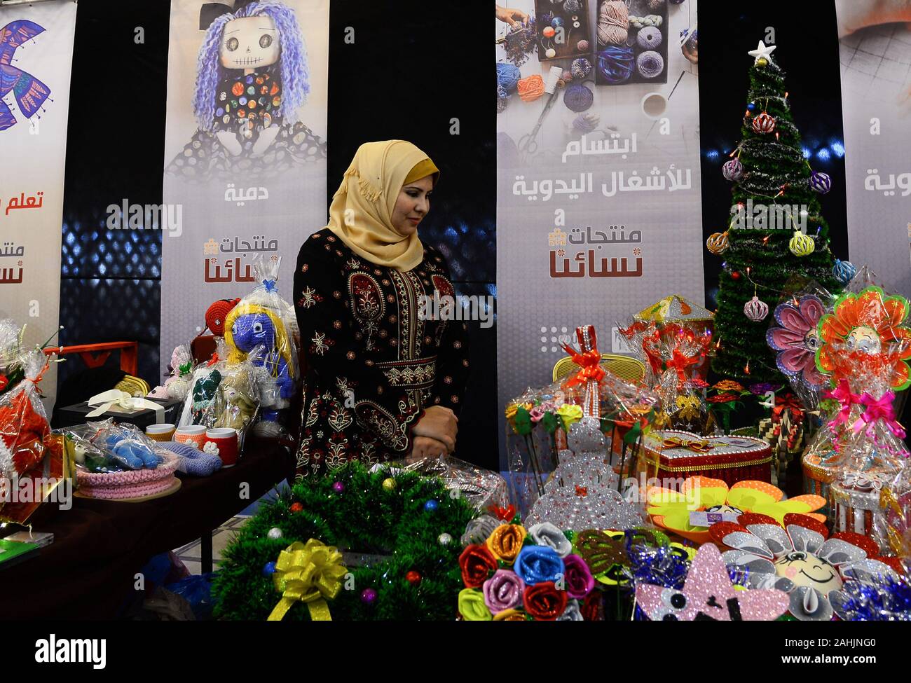Gaza. 30th Dec, 2019. A Palestinian woman takes part in 'Our Women Product' exhibition in Gaza City, Dec. 30, 2019. The exhibition displayed Palestinian fashion and other products for women. Credit: Rizek Abdeljawad/Xinhua/Alamy Live News Stock Photo