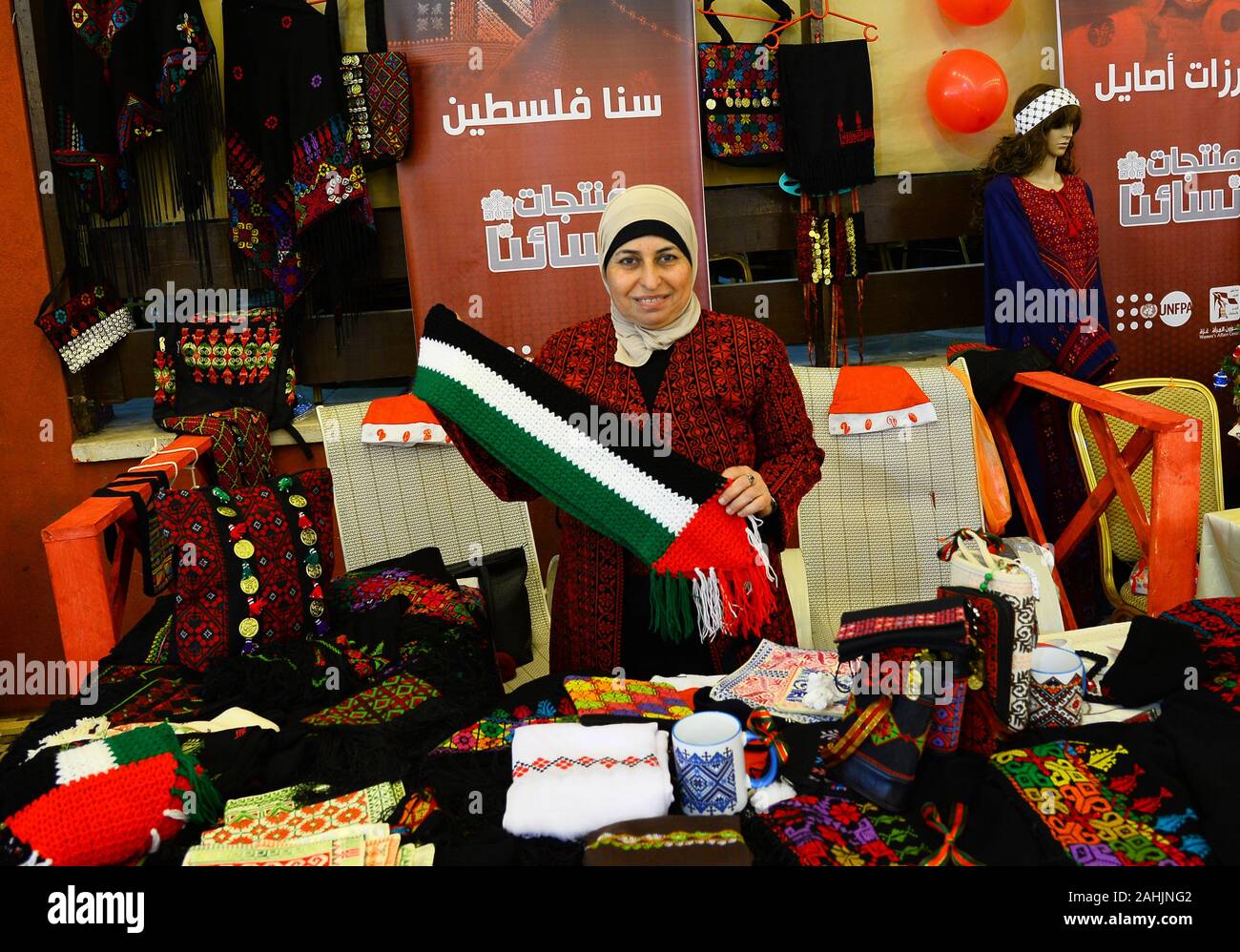 Gaza. 30th Dec, 2019. A Palestinian woman takes part in 'Our Women Product' exhibition in Gaza City, Dec. 30, 2019. The exhibition displayed Palestinian fashion and other products for women. Credit: Rizek Abdeljawad/Xinhua/Alamy Live News Stock Photo