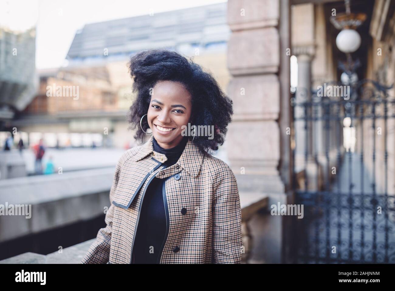 Beautiful african american young woman with afro and large hoop ...