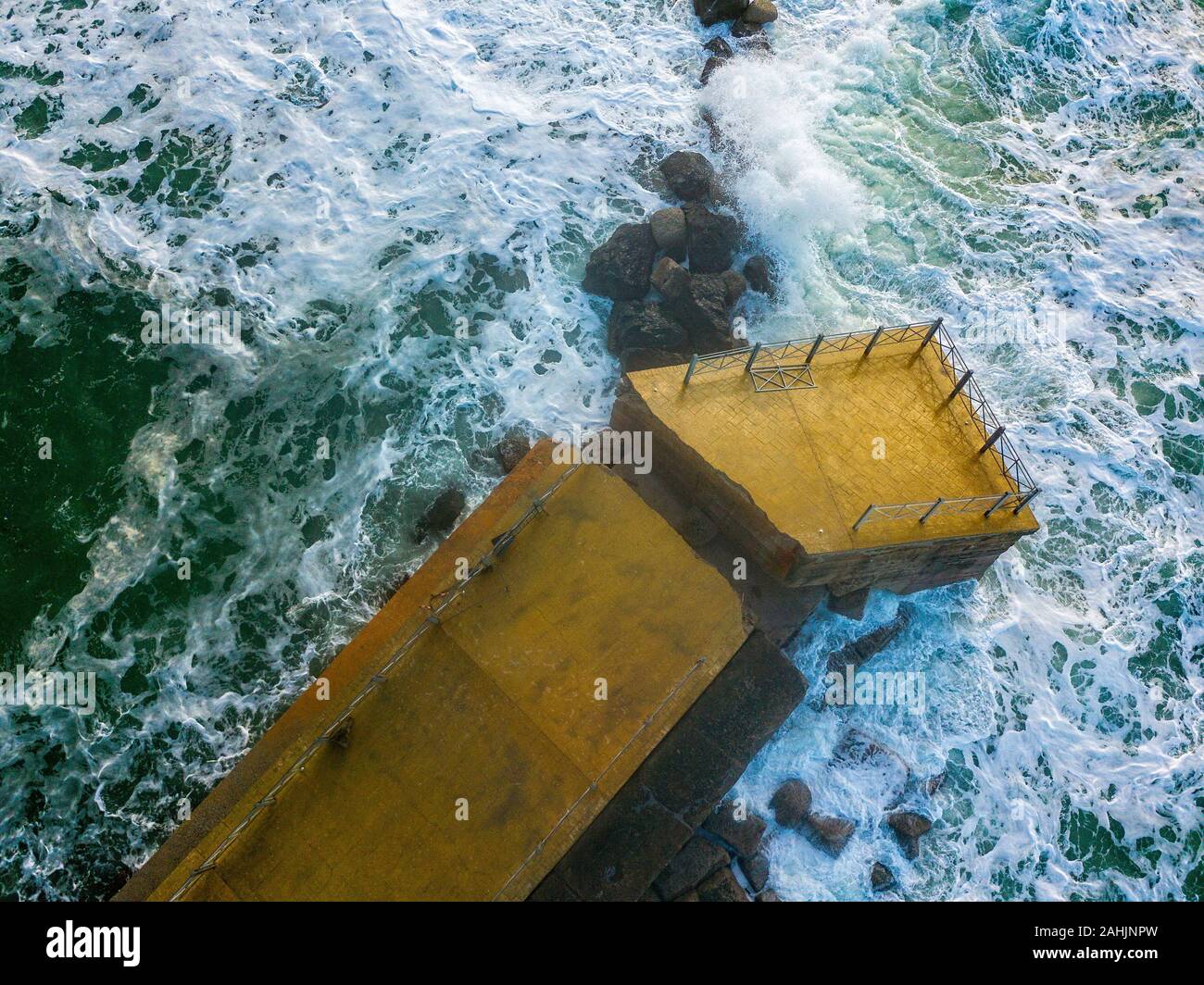 Aerial view of a pier with rocks. Pizzo Calabro pier. Broken pier, force of the sea. Natural disasters, climate change. Calabria, Italy Stock Photo