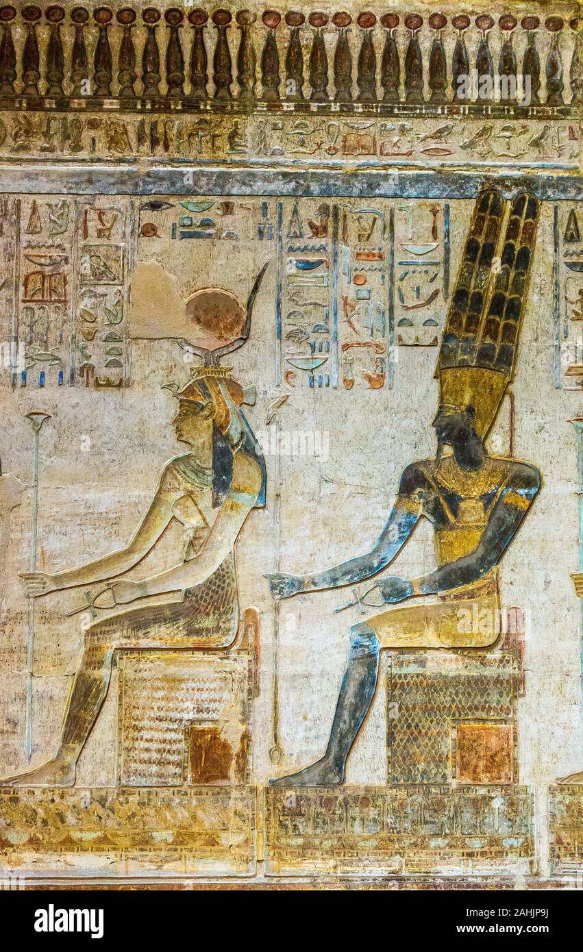 UNESCO World Heritage, Thebes in Egypt, ptolemaic temple of Deir el Medineh. Hathor and Amun-Ra seated on thrones. Stock Photo