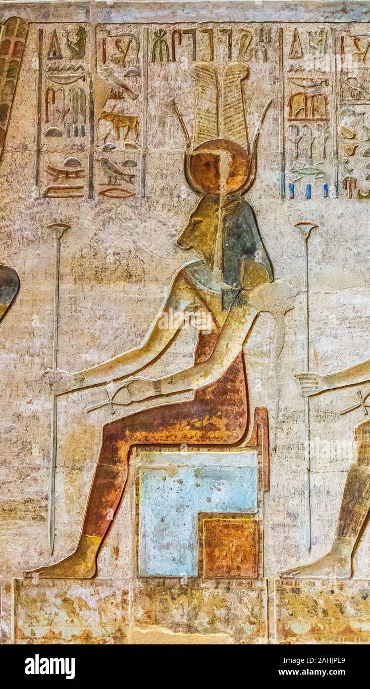UNESCO World Heritage, Thebes in Egypt, ptolemaic temple of Deir el Medineh. The goddess Ihet seats on a throne, she wears a red tunic and a collar. Stock Photo