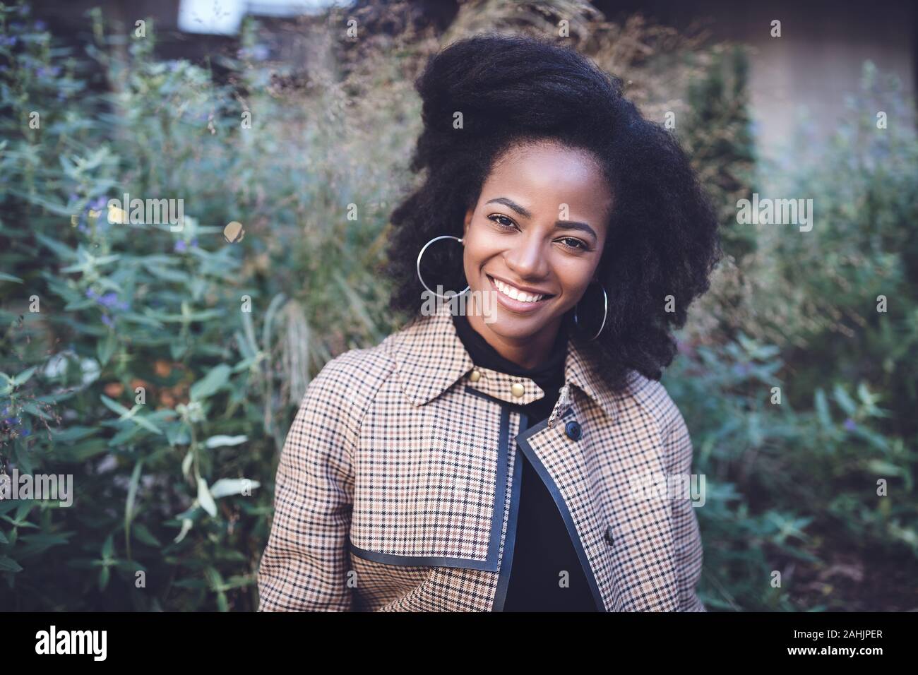 Beautiful african american young woman with afro and large hoop ...