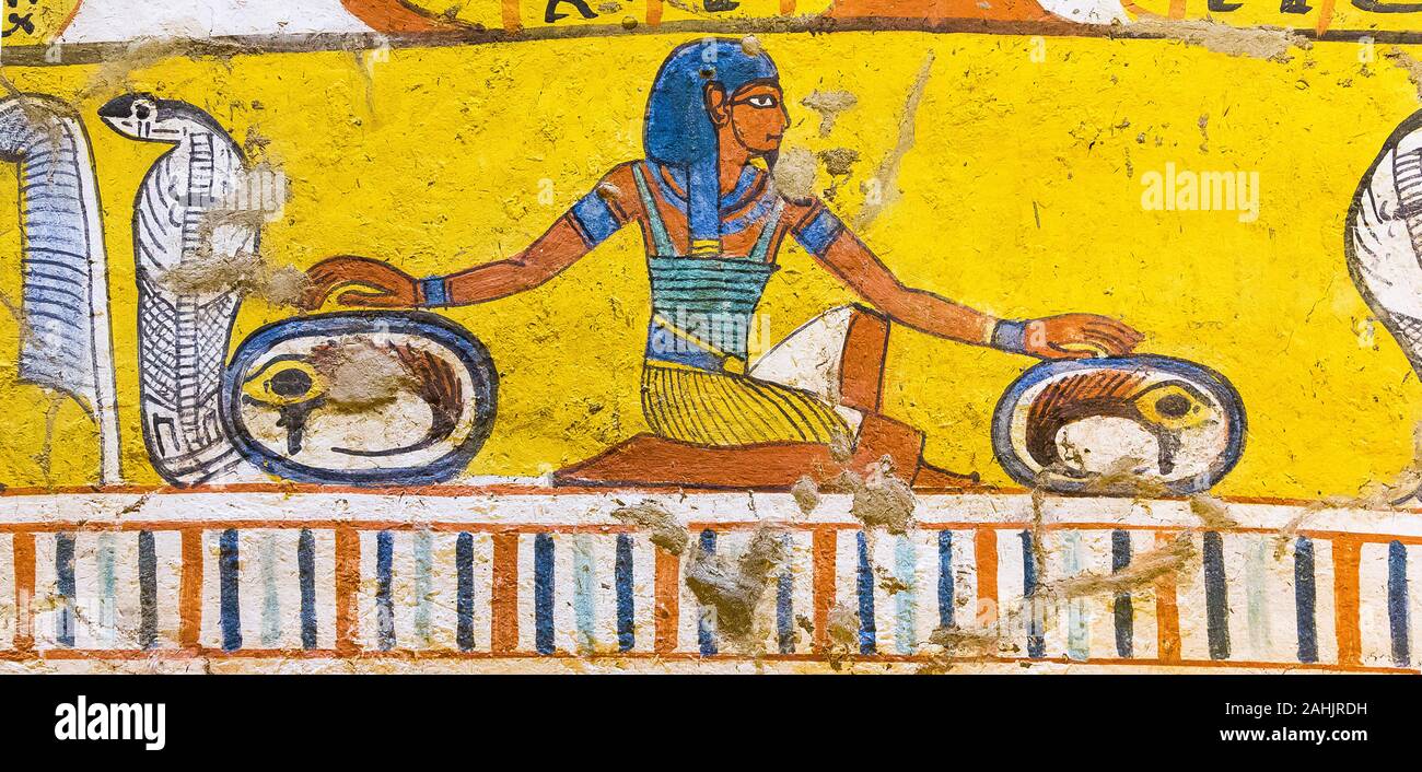 UNESCO World Heritage, Thebes in Egypt, Deir el Medineh, tomb of Irynefer. A god, maybe  Heh or Shu, cures 2 eyes of Horus (Udjat). Stock Photo
