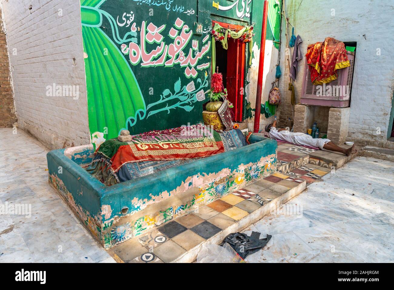 Sehwan Sharif Darbar Shah Mardan Sikandar Bodla Bahar Tomb Picturesque View of Grave Coffin and a Sleeping Man on a Sunny Blue Sky Day Stock Photo