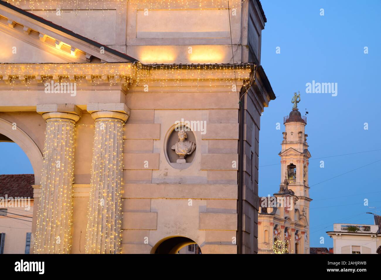 Italy, Lombardy, Crema, Porta Ombriano Gate background Church of the Santissima Trinita, Christmas Lights Stock Photo
