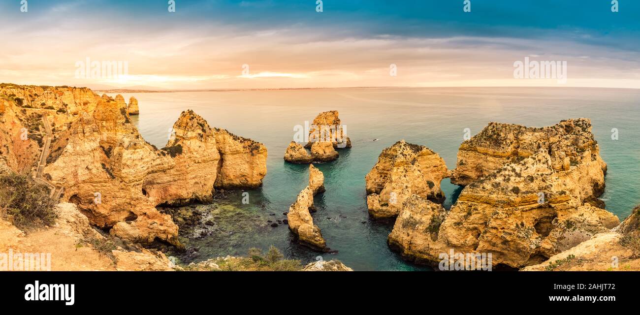 Panorama of Ponta da Piedade cliffs at sunset near Lagos, Portugal. Beautiful seascape with natural rock formations in the Algarve, portuguese tourist Stock Photo