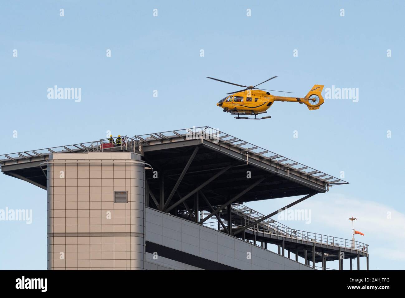 Scottish Air Ambulance Ambulance Airbus Helicopter G-SASS above the rooftop helipad at Queen Elizabeth University Hospital, Glasgow, Scotland, UK Stock Photo