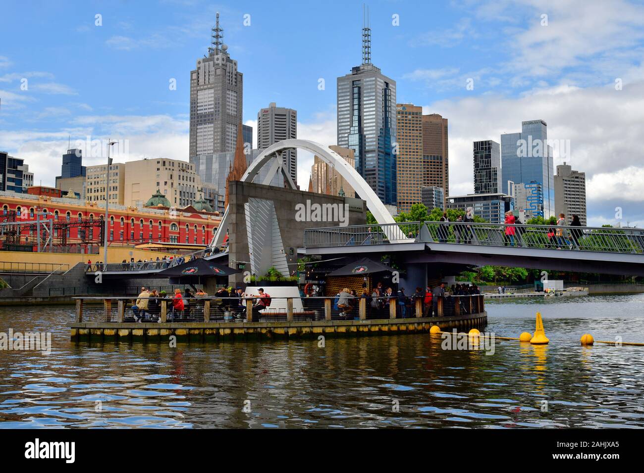 Melbourne, VIC, Australia - November 03, 2017: Unidentified people in cafe on Evan Walker bridge in midst Yarra river, preferred place for tourists and Stock Photo