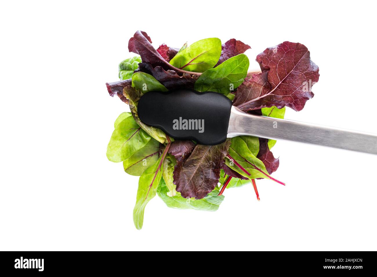 Tongs with mix salad leaves isolated on white Stock Photo Alamy