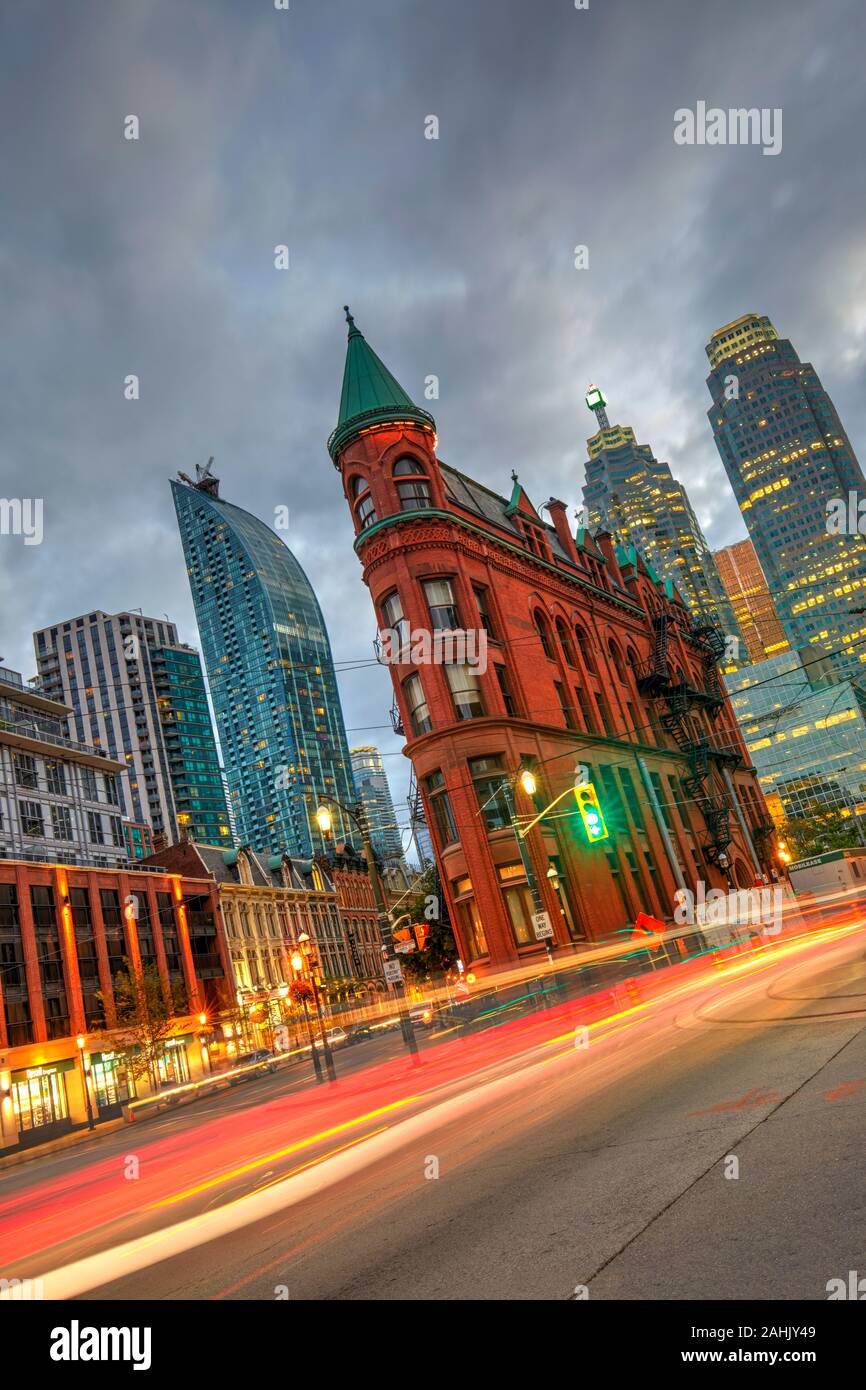 Gooderham Building, also known as the Flatiron Building, during the blue hour with light trails, Toronto, Canada Stock Photo
