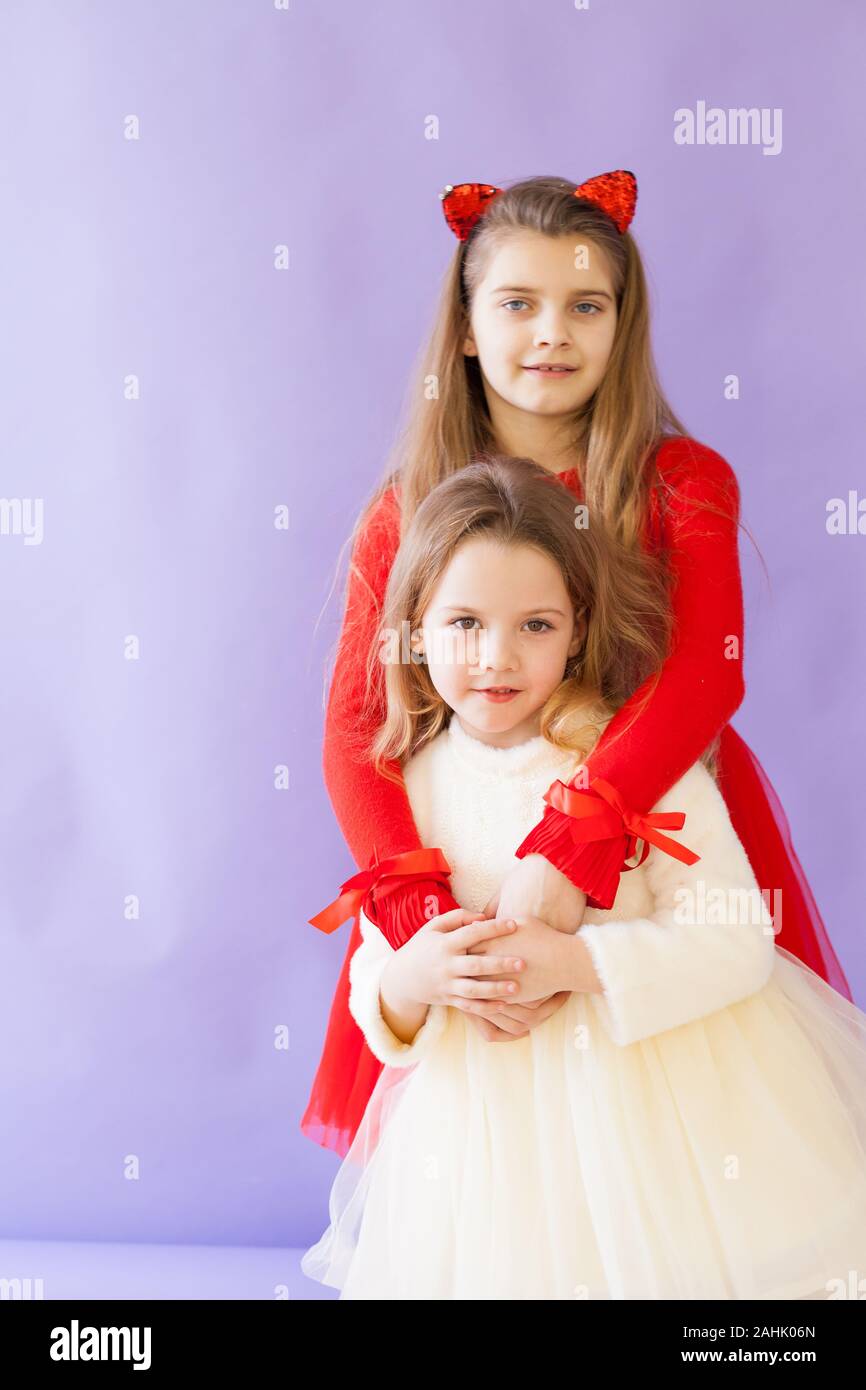 Two beautiful little girls in red and white sister friend dresses Stock ...