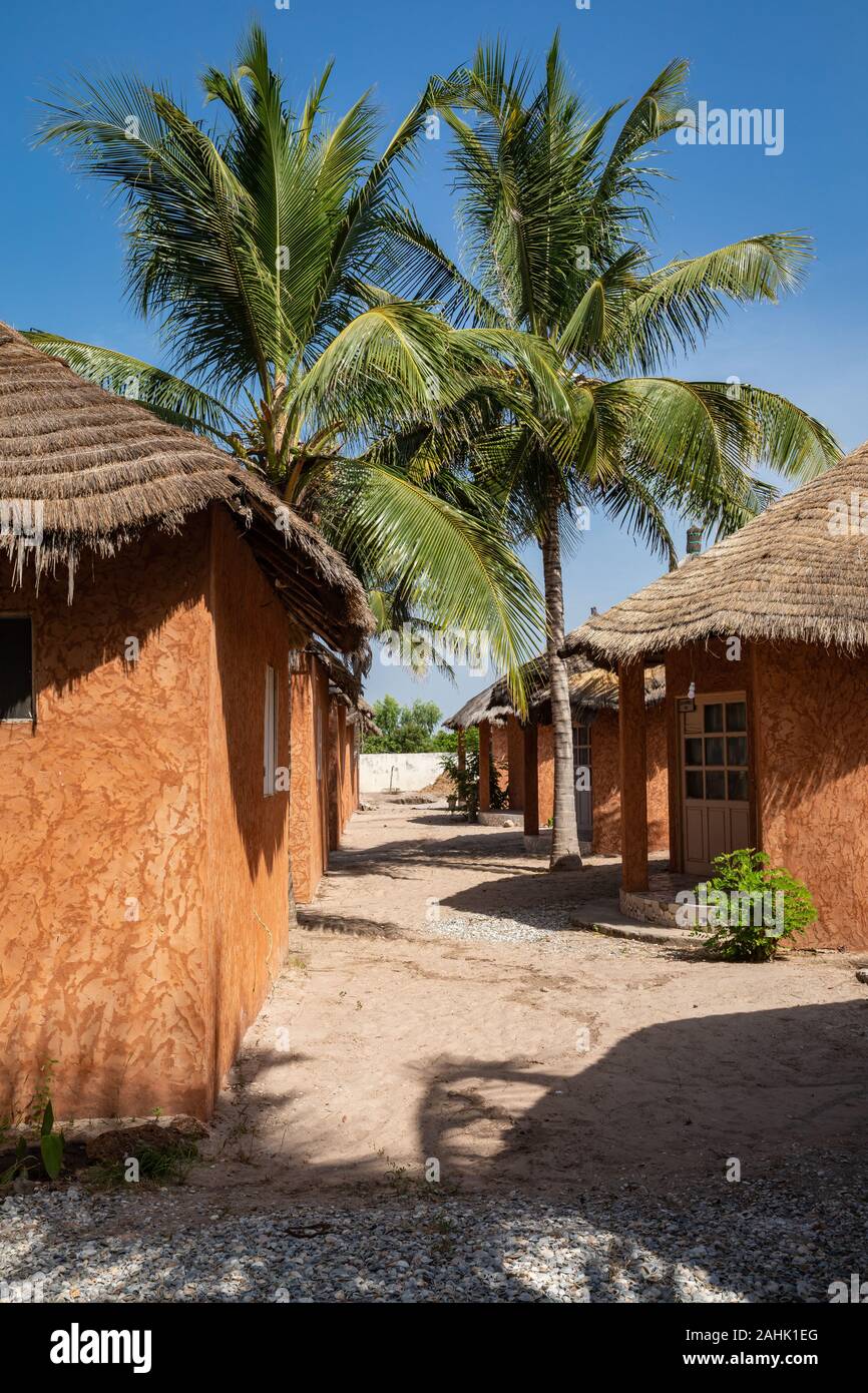 Traditional tourist resort in Senegal. Big green palms. Stock Photo