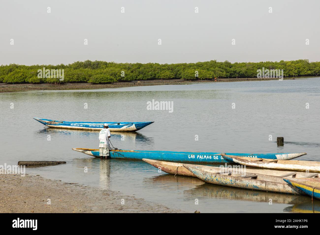 JOAL-FADIOUTH, SENEGAL - NOVEMBER15, 2019: Fishers and small long boats. Fadiauth Island. Senegal. West Africa. Stock Photo