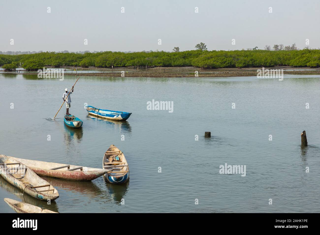 JOAL-FADIOUTH, SENEGAL - NOVEMBER15, 2019: Fishers and small long boats. Fadiauth Island. Senegal. West Africa. Stock Photo