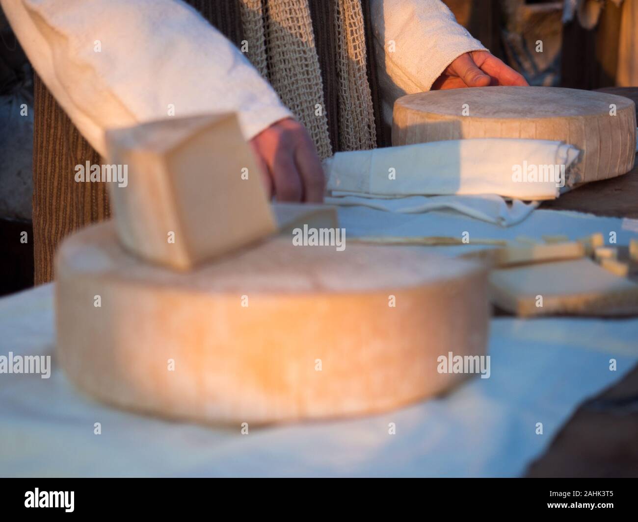 Selling cheese at a market stall in a rural area. Stock Photo