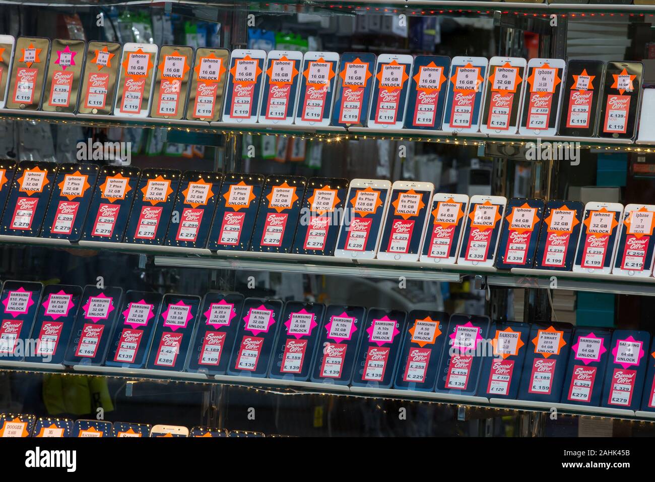 Second hand mobile phones for sale in a shop window in Walthamstow. Stock Photo