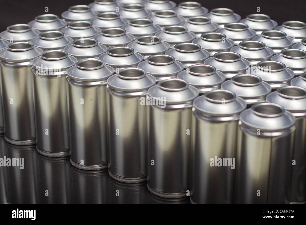 A large number of aerosol cans on a black background Stock Photo - Alamy